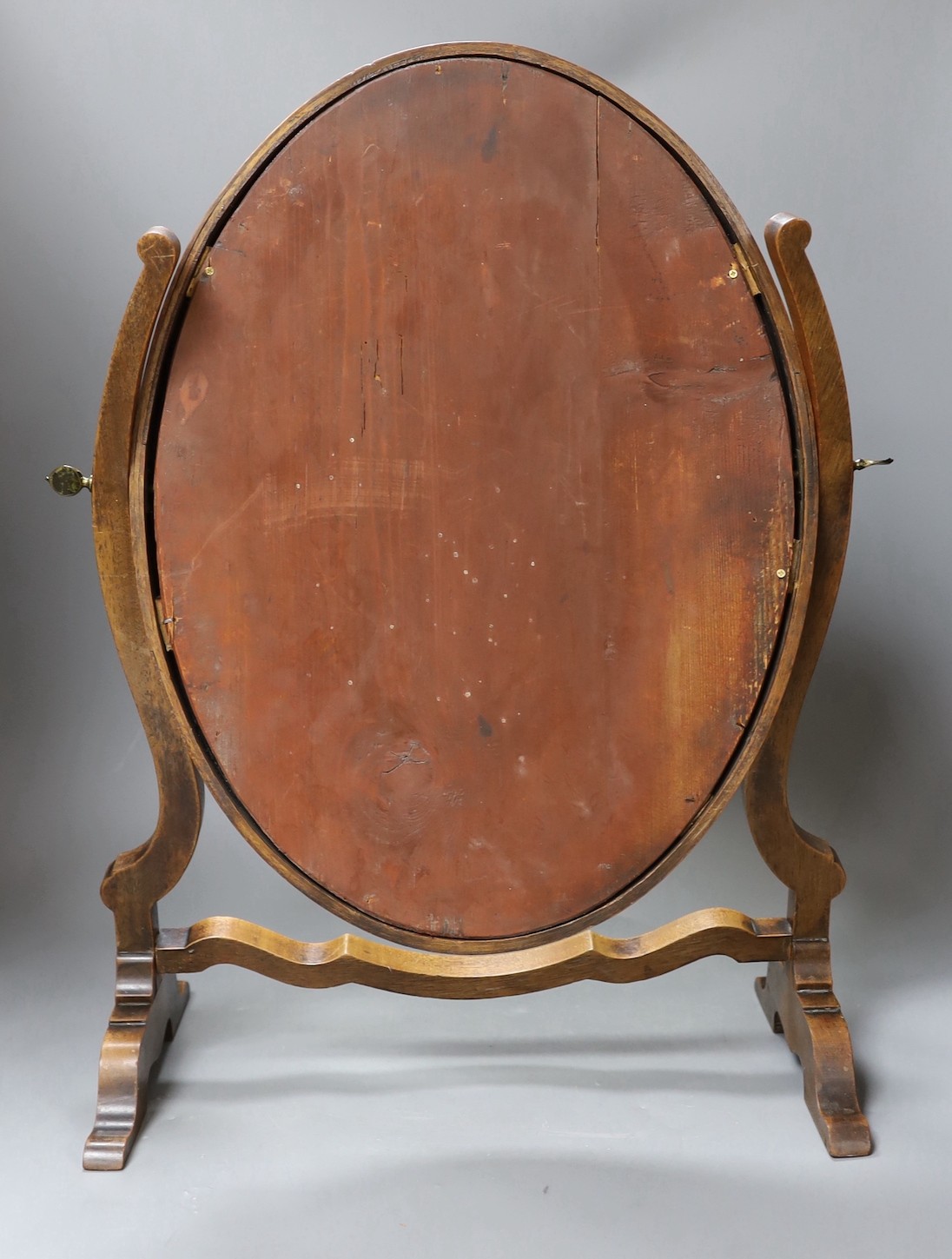 A swing mahogany frame toilet mirror with satinwood banding, 53cm tall